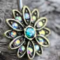 Piercing nombril fleur dorée aurore boréale