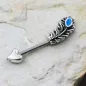 Piercing téton flèche et plume turquoise